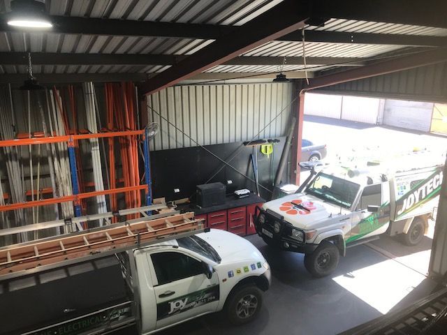 A Couple Of Trucks Are Parked In A Garage — Joytech In Ciccone, NT