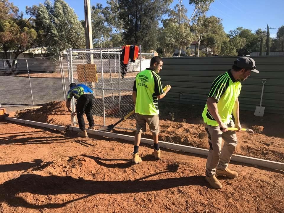 A Group Of Construction Workers Are Working On A Dirt Road — Joytech In Ciccone, NT