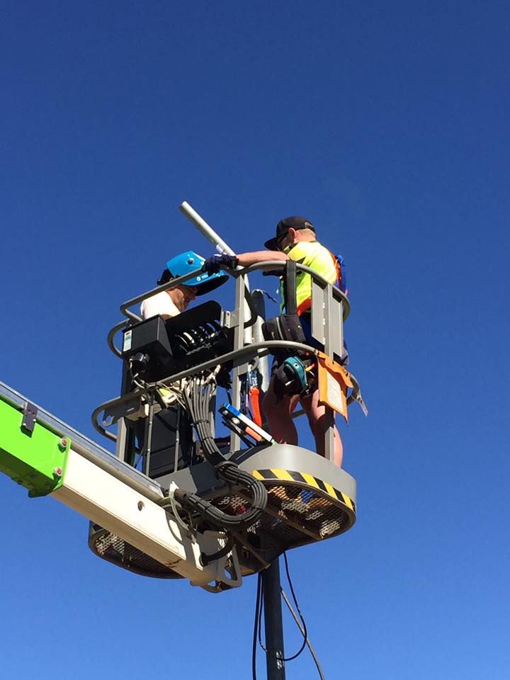 A Man In A Bucket Is Working On A Pole — Joytech In Ciccone, NT