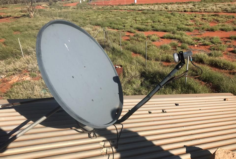 A Satellite Dish Is Sitting On Top Of A Metal Roof — Joytech In Ciccone, NT
