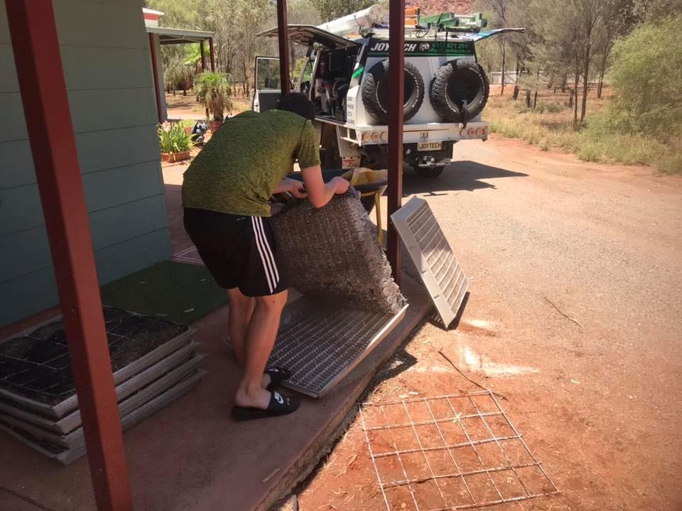 A Man Is Standing On A Porch Next To A Truck — Joytech In Ciccone, NT