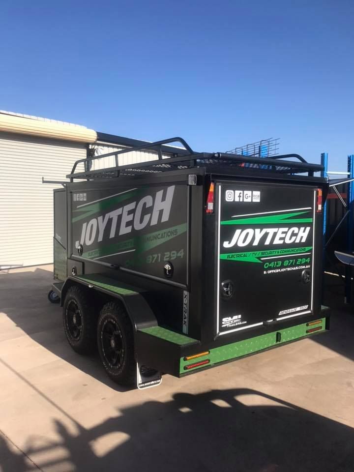 A Black And Green Trailer Is Parked In Front Of A Building — Joytech In Ciccone, NT