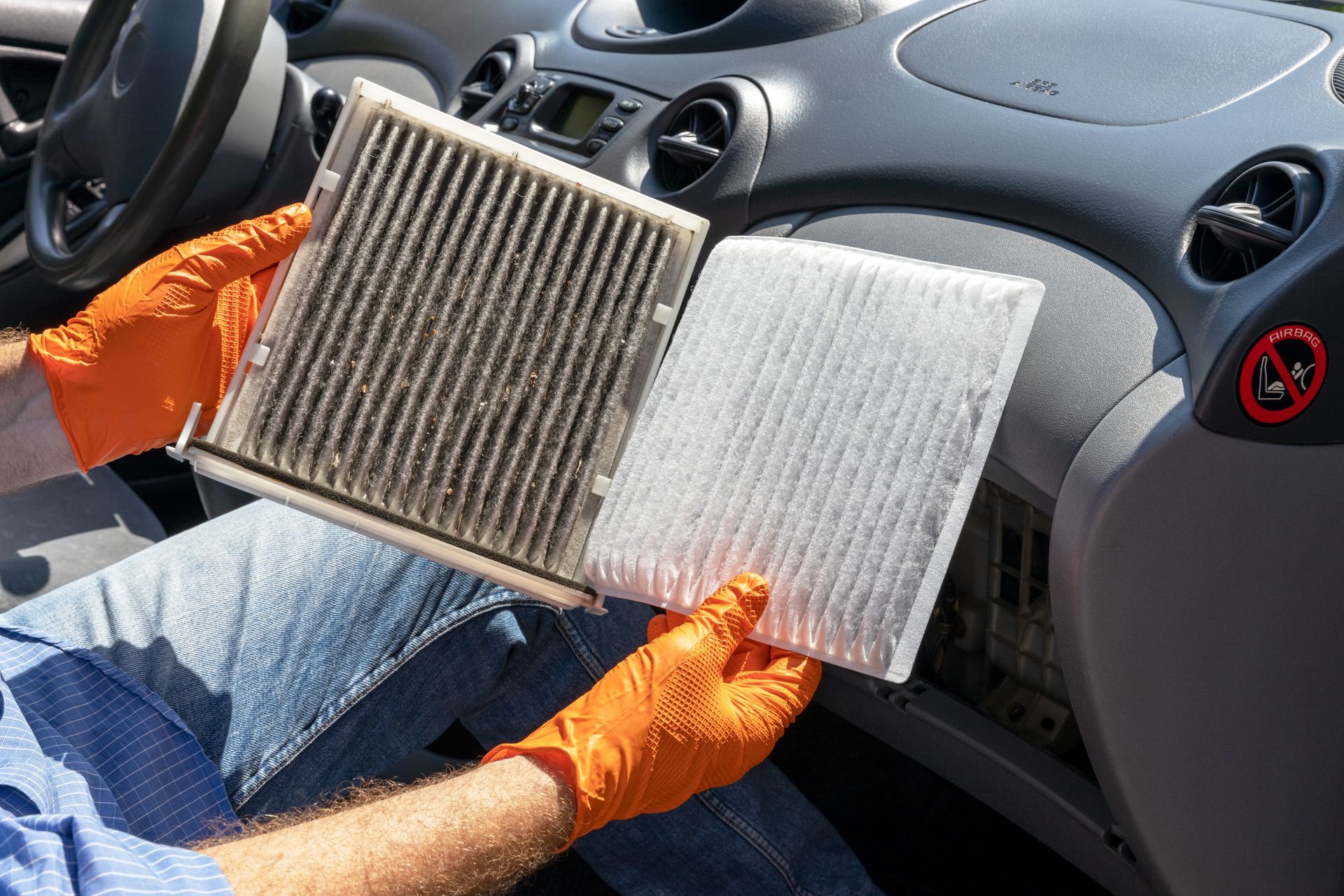 A person is pouring oil into a car engine.