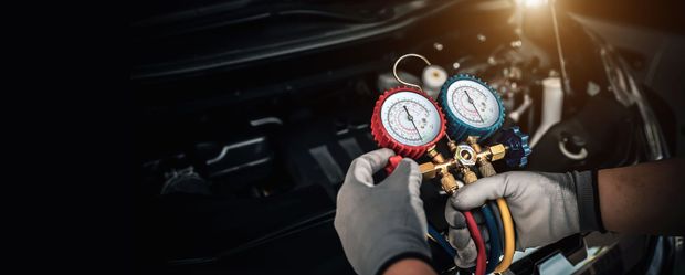 A person is pouring oil into a car engine.