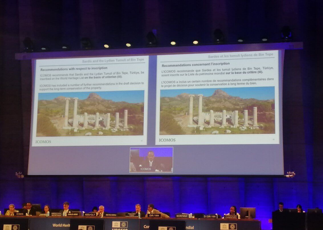 A presentation slide at a UNESCO meeting, showing an image of ancient ruins
