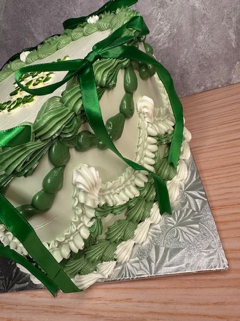 Baker putting cream on a layer of a cake