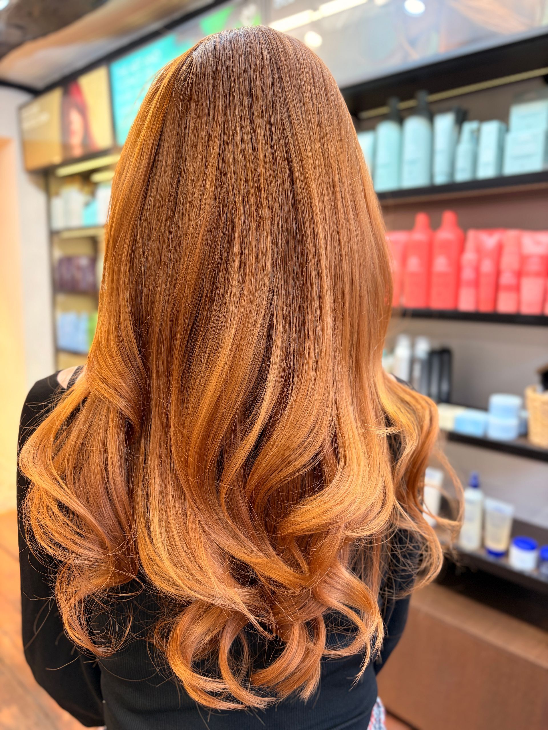 big bouncy blow dry on copper coloured long hair