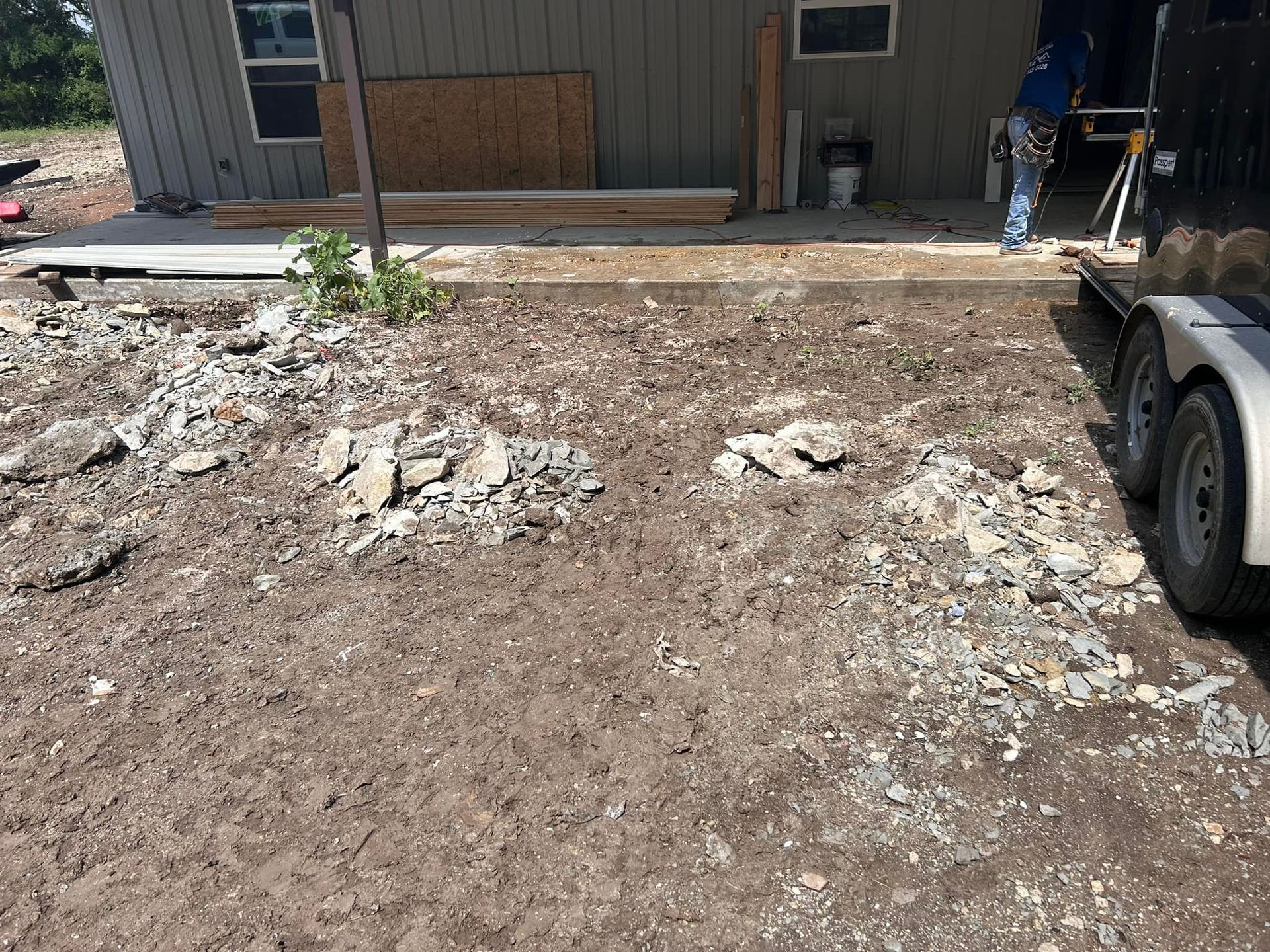 A trailer is parked in front of a house under construction.