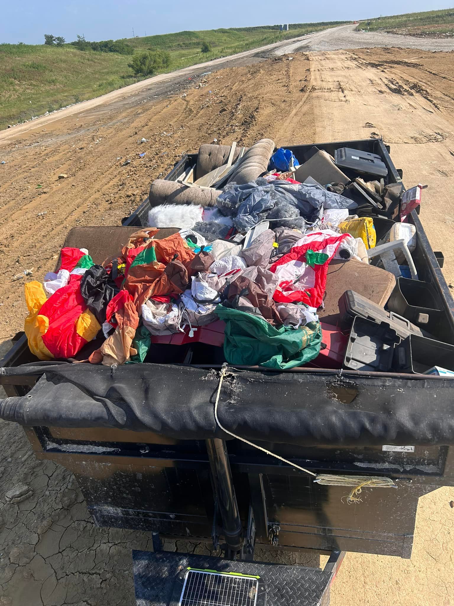 A truck bed filled with lots of stuffed animals and christmas decorations.