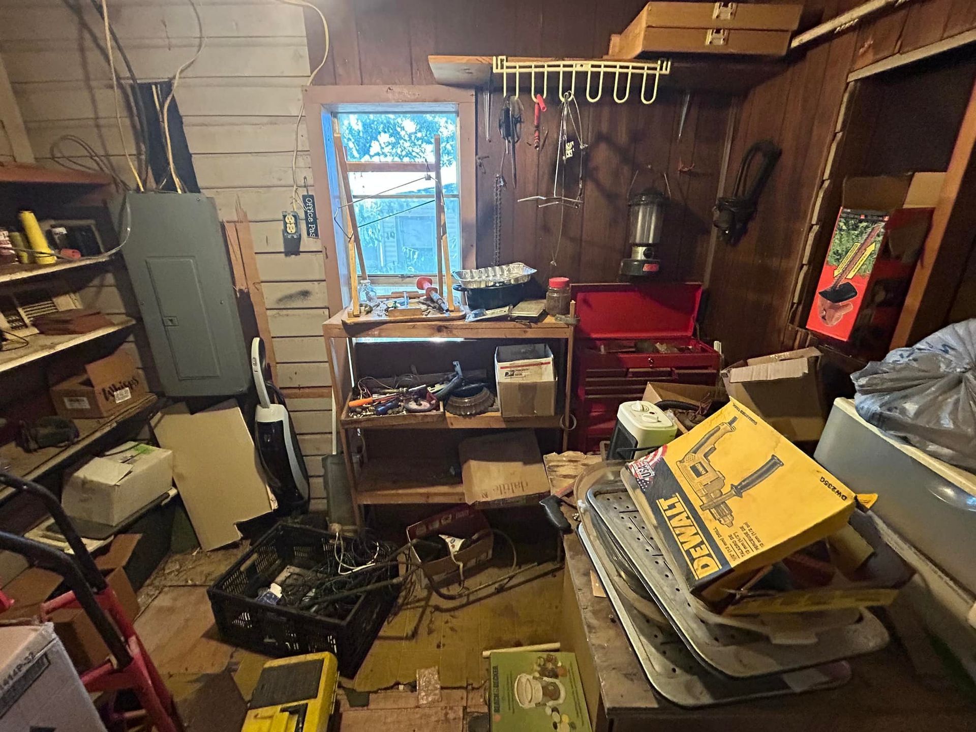 A messy garage filled with lots of tools and boxes.