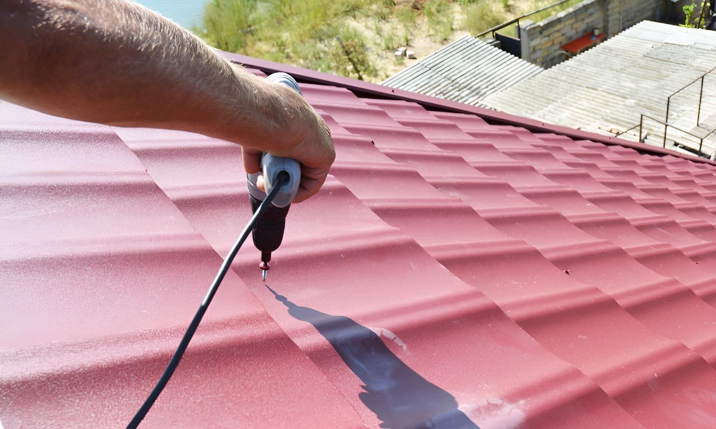 Person is Using a Drill on a Tile Roof — Above All Roof Painters & Repairs in Bellmere, QLD