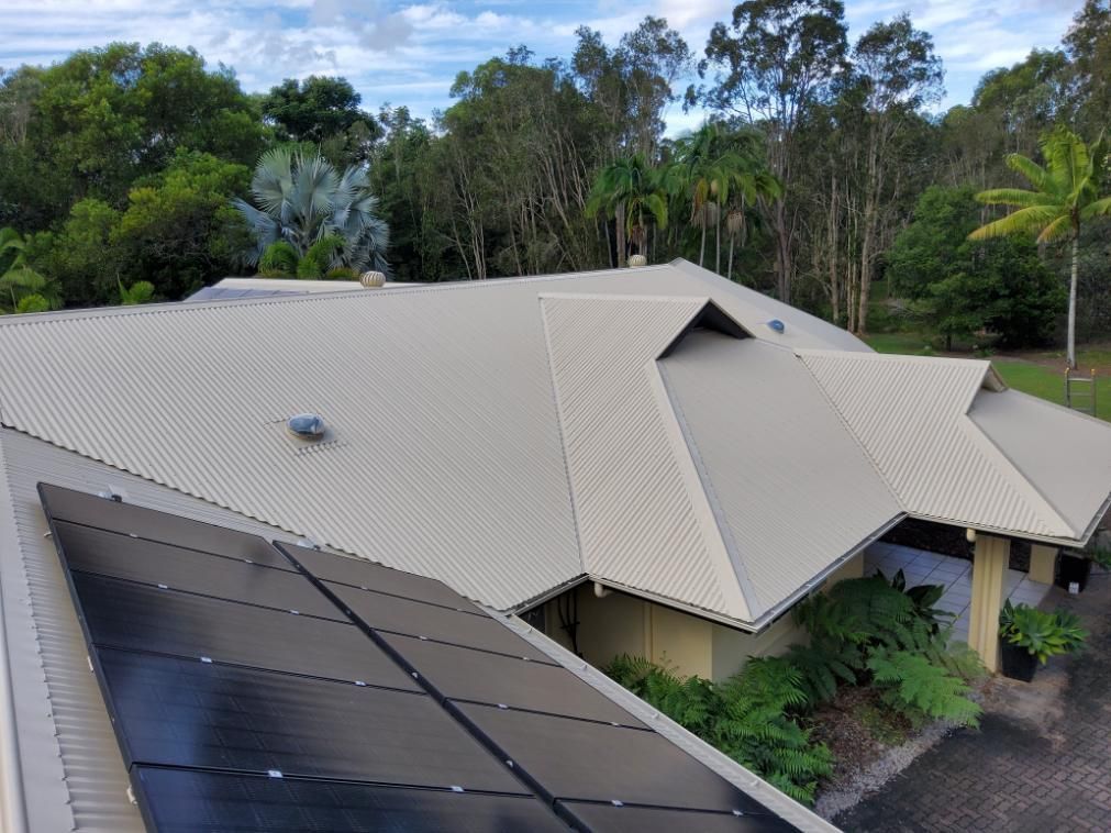 Aerial View of a House With Solar Panels on the Roof — Above All Roof Painters & Repairs in Bellmere, QLD