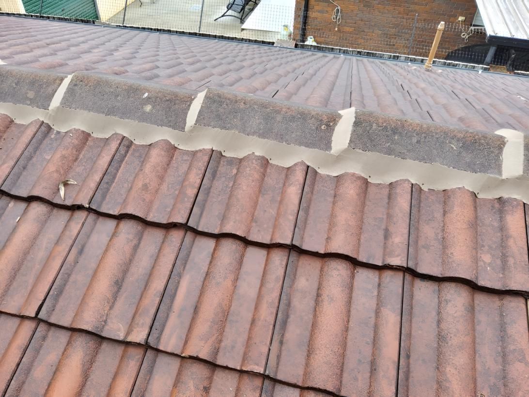 Close Up of a Tiled Roof With a Metal Roof — Above All Roof Painters & Repairs in Bellmere, QLD