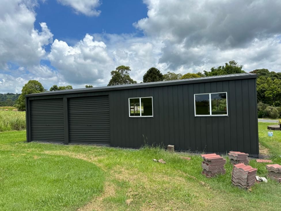 Black Garage With Two Doors and Two Windows — Above All Roof Painters & Repairs in Redcliffe, QLD