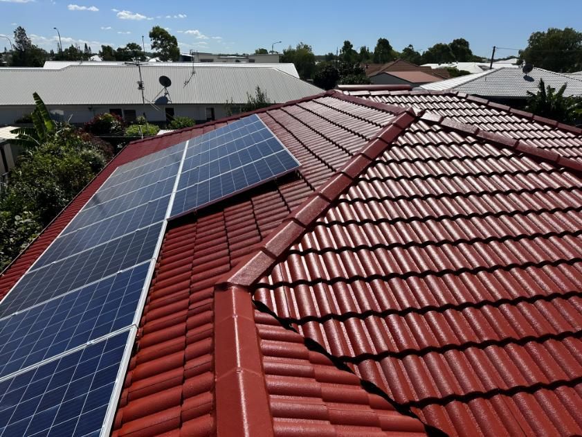 Red Tiled Roof With Solar Panels on It — Above All Roof Painters & Repairs in Burpengary, QLD