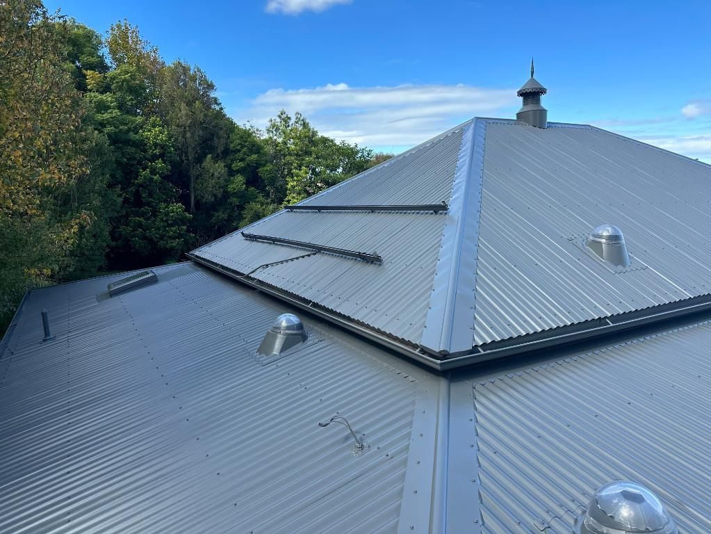 Large Metal Roof With a Chimney on Top of It — Above All Roof Painters & Repairs in Bellmere, QLD