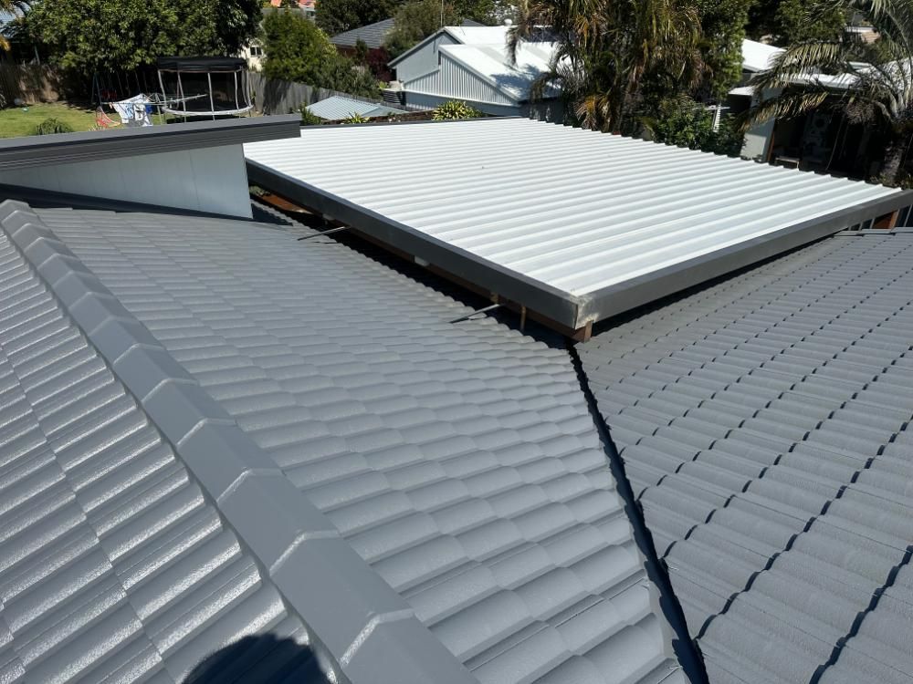 Gray Tiled Roof With a White Roof Covering — Above All Roof Painters & Repairs in Caboolture, QLD