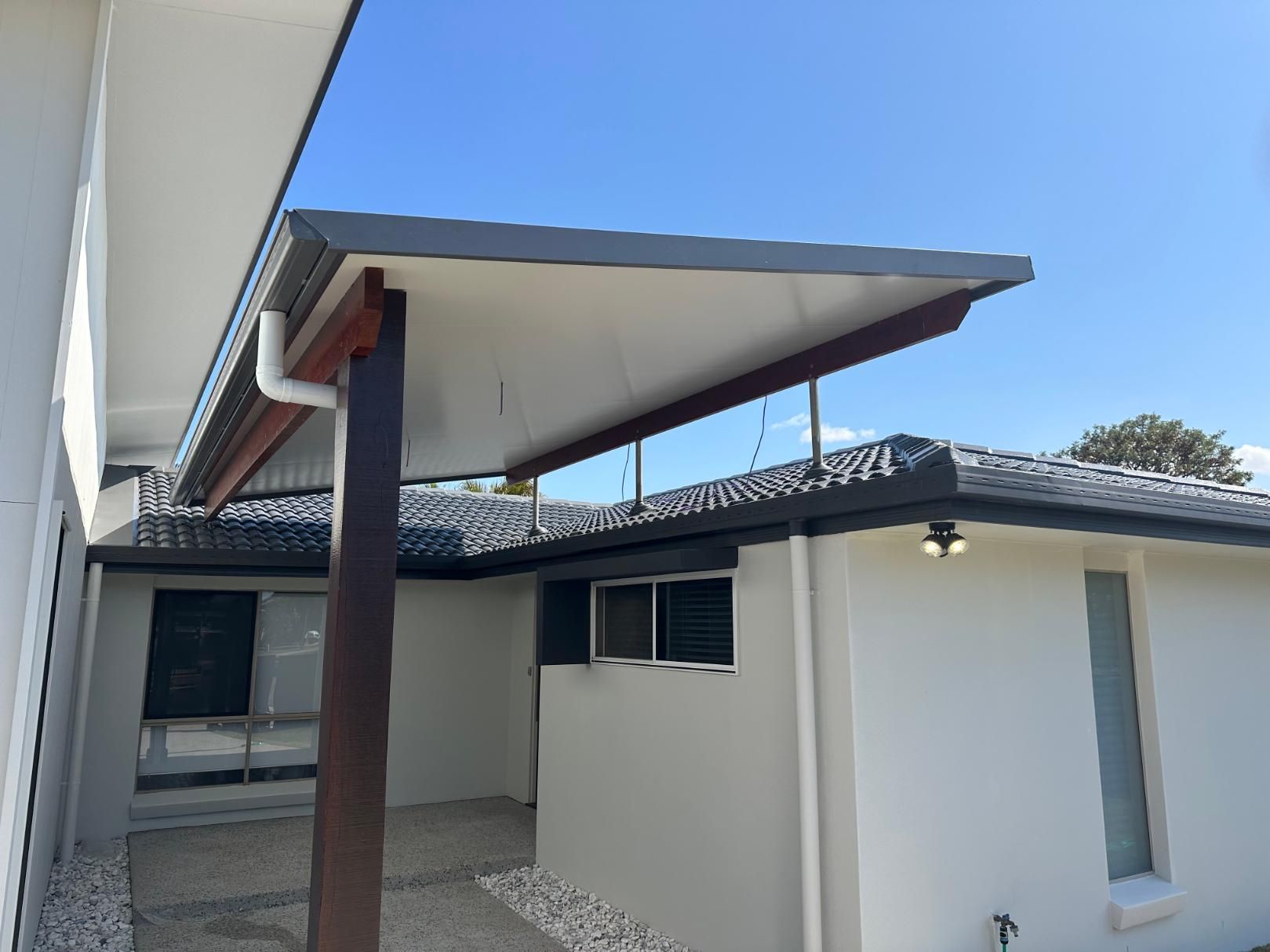 White House With a Covered Walkway and a Roof — Above All Roof Painters & Repairs in Bellmere, QLD