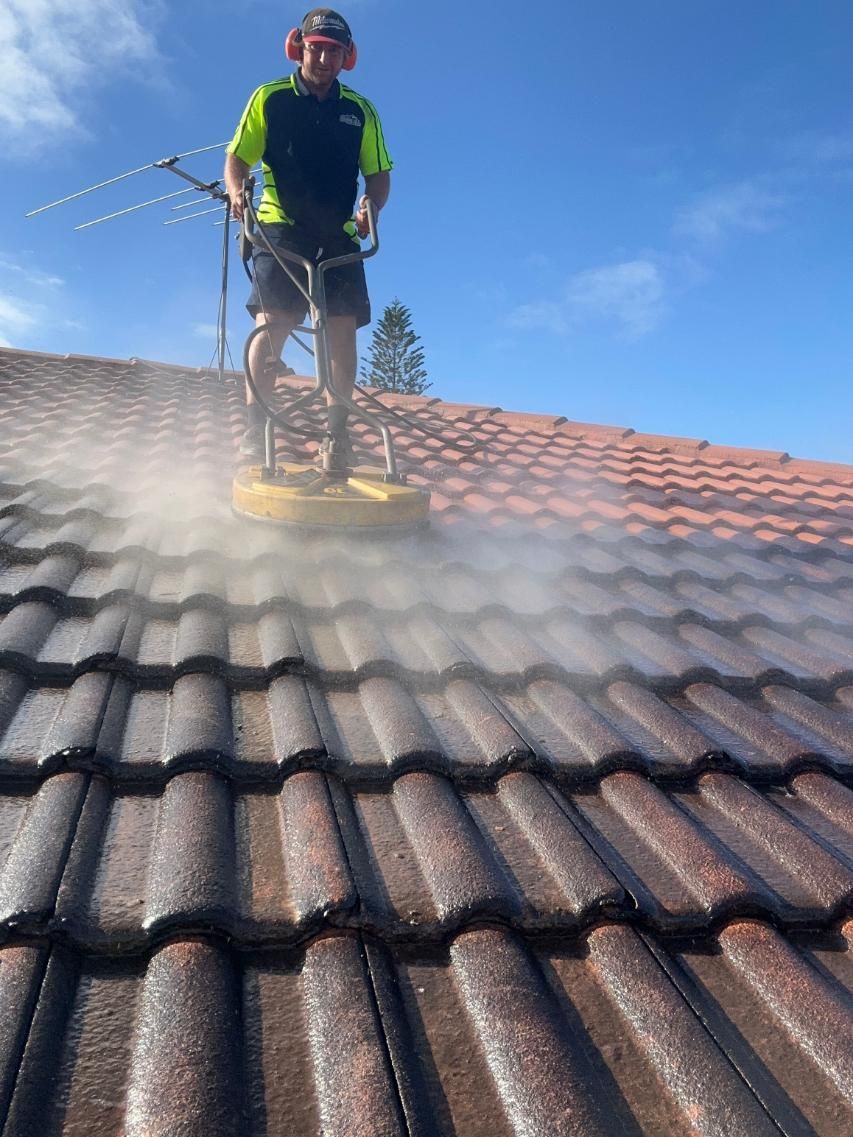 Man is Cleaning a Tiled Roof With a Machine — Above All Roof Painters & Repairs in Bellmere, QLD