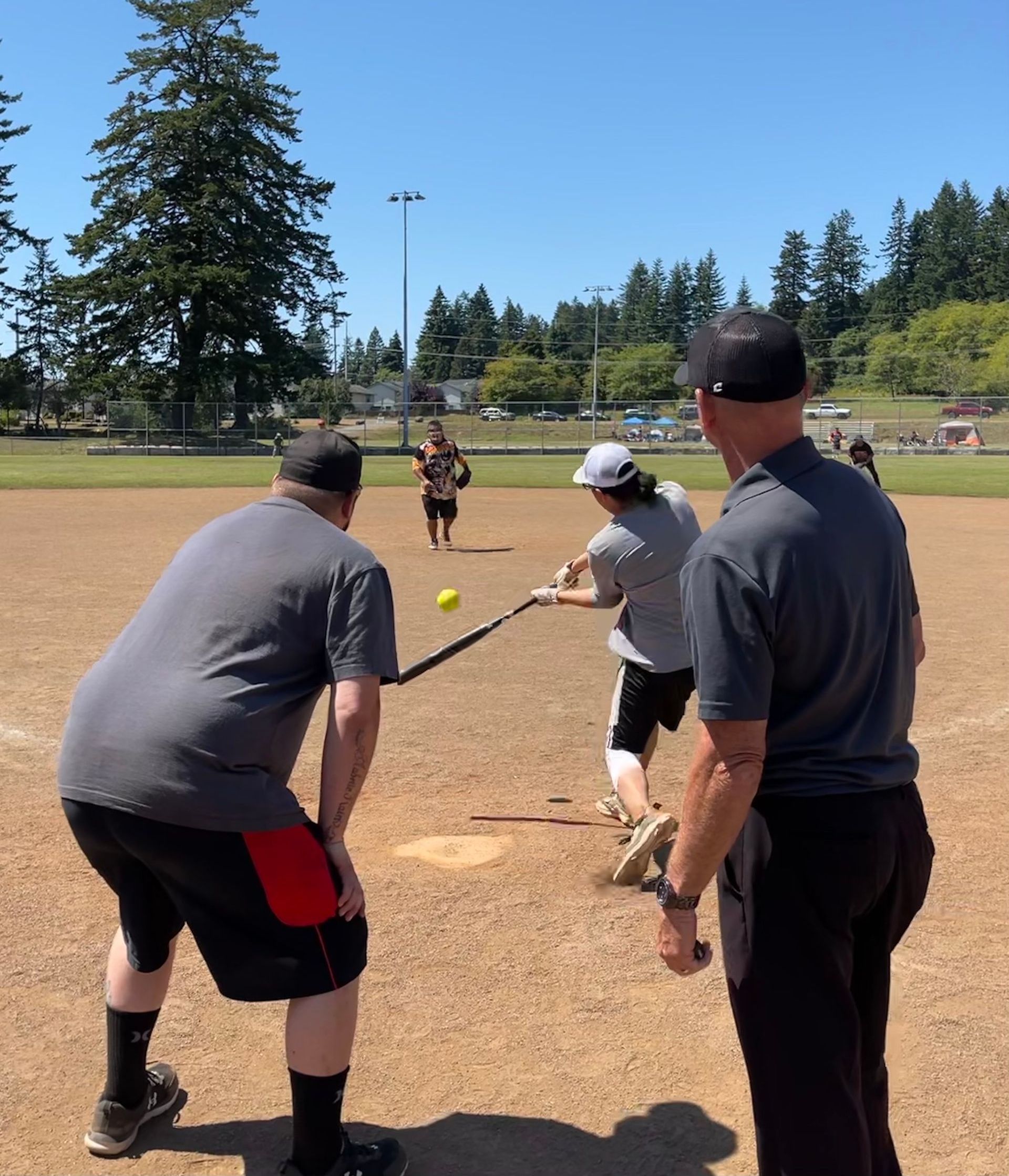 A group of people are playing a game of softball