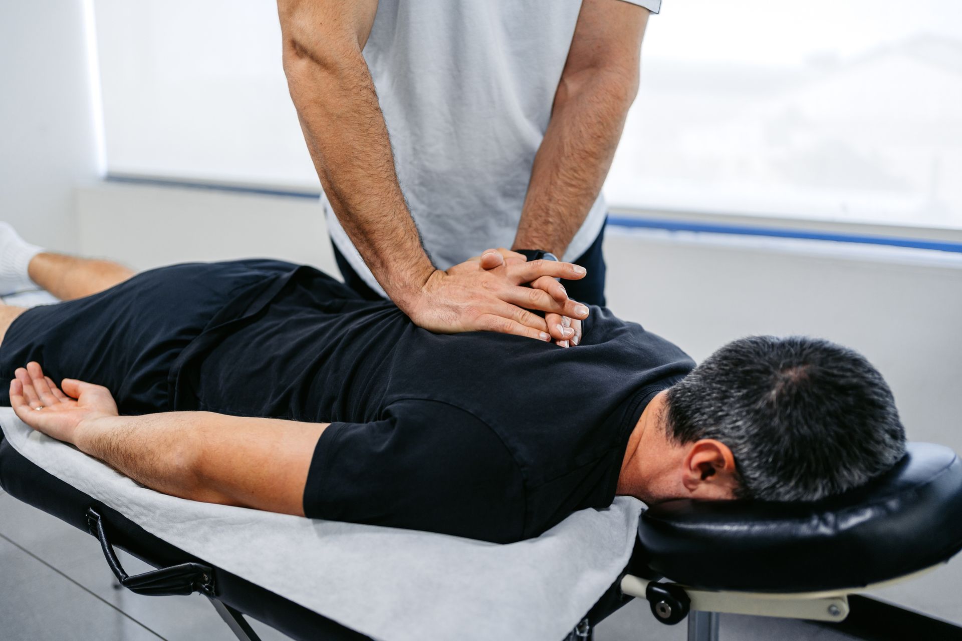 Man is laying on a Table getting a massage from a Doctor - Terre Haute, IN - Advanced Chiropractic Center