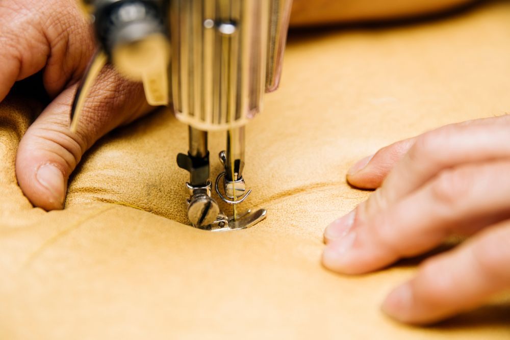 A Person Is Using A Sewing Machine — The Sewing Machine Doctor In Forest Glen, QLD