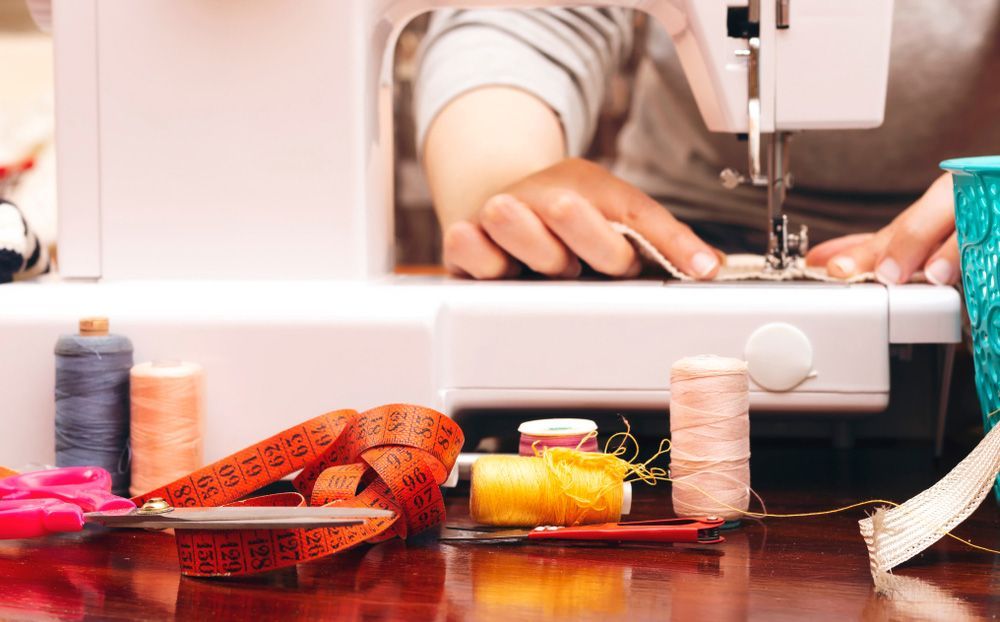 A Person Is Using A Sewing Machine On A Table — The Sewing Machine Doctor In Forest Glen, QLD