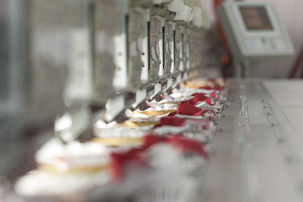 A Row Of Cupcakes Sitting On Top Of A Conveyor Belt — The Sewing Machine Doctor In Forest Glen, QLD