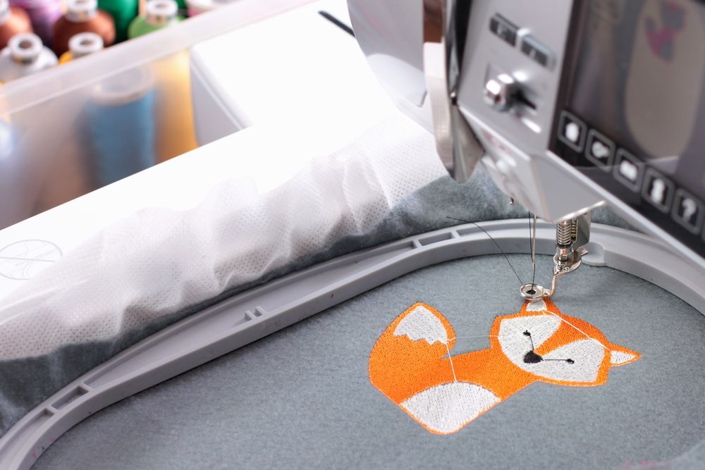 A Sewing Machine Is Embroidery A Fox On A Piece Of Fabric — The Sewing Machine Doctor In Forest Glen