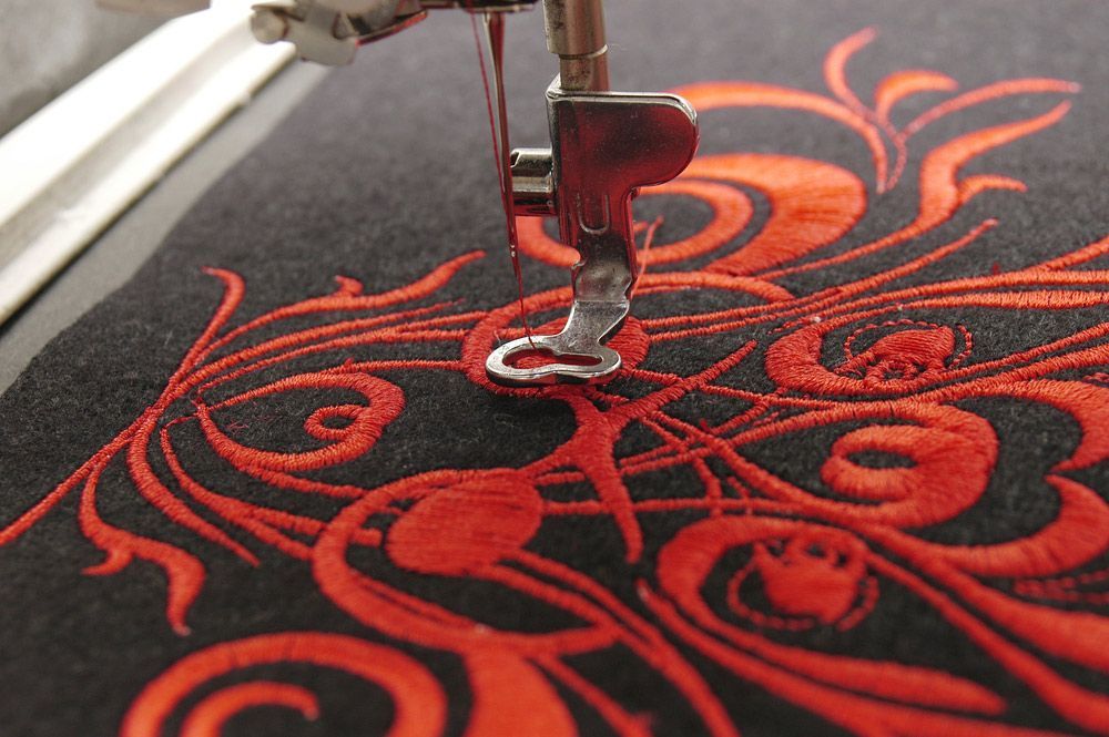 A Close Up Of A Sewing Machine With Red Embroidery — The Sewing Machine Doctor In Forest Glen, QLD