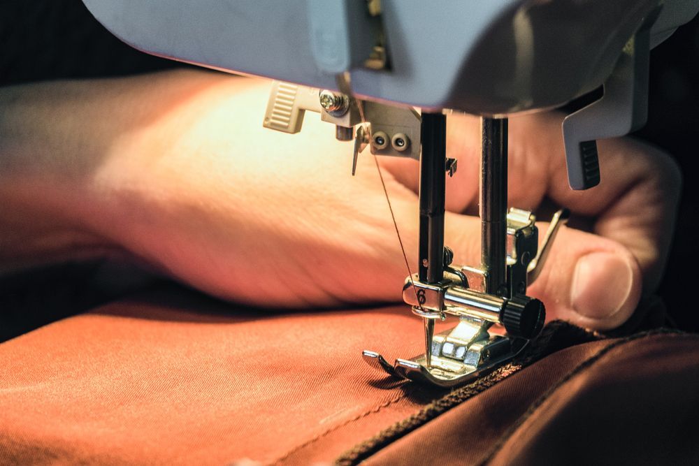 A Person Is Using A Sewing Machine — The Sewing Machine Doctor In Forest Glen, QLD