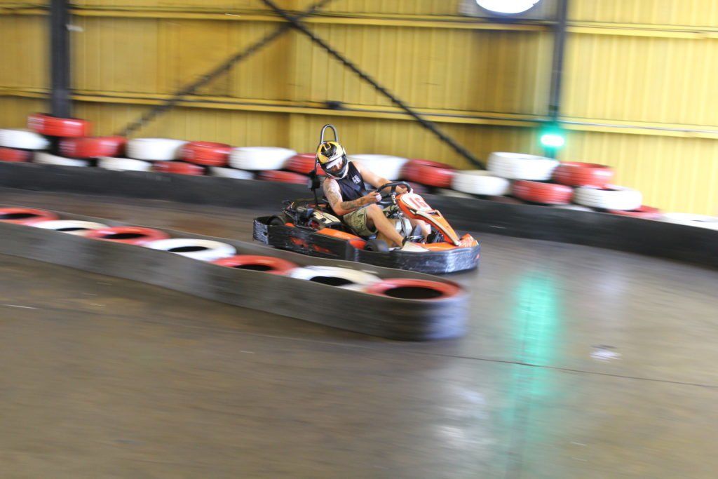 A person is riding a go kart on a track.