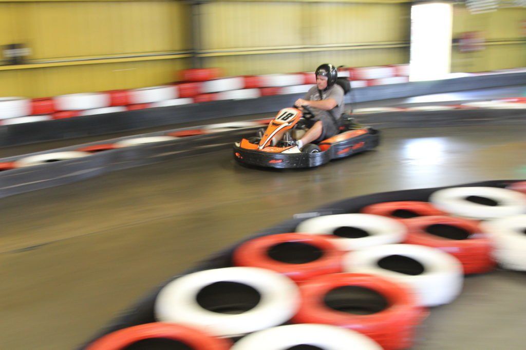 A person is riding a go kart on a track