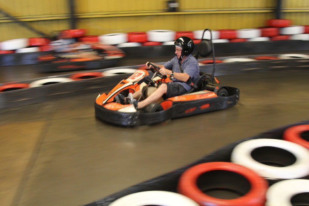 A man is riding a go kart on a track