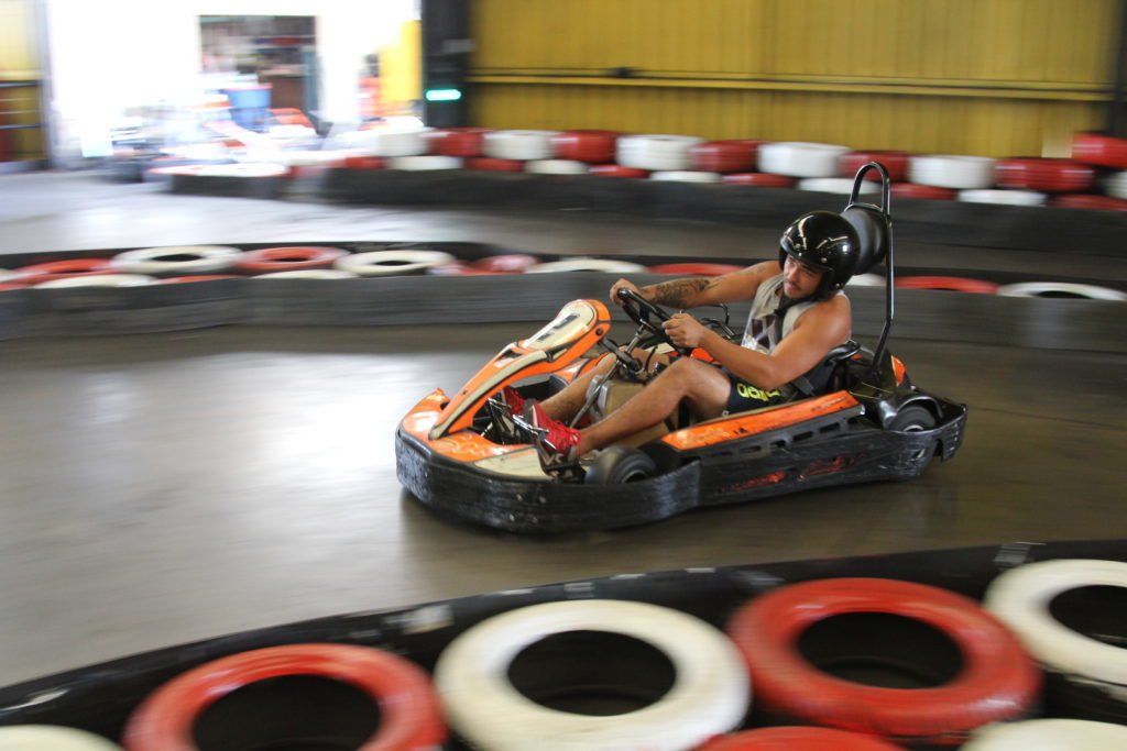 A person is riding a go kart on a track