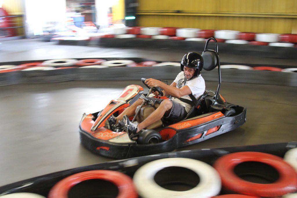 A man is riding a go kart on a track