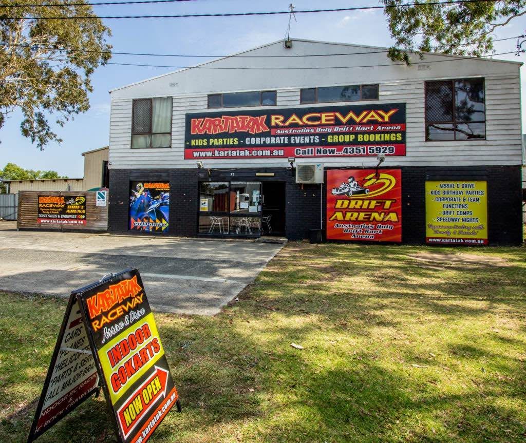 A building with a sign in front of it that says raceway