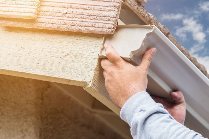 Person holding a gutter.