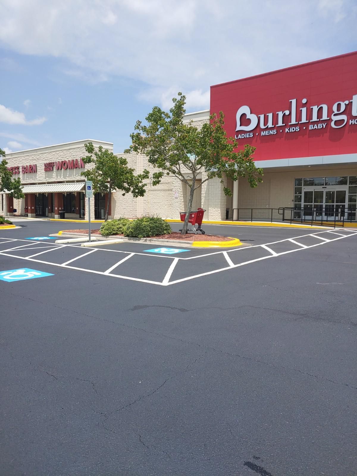 Burlington store exterior with accessible parking spaces and a shopping cart; sunny day.