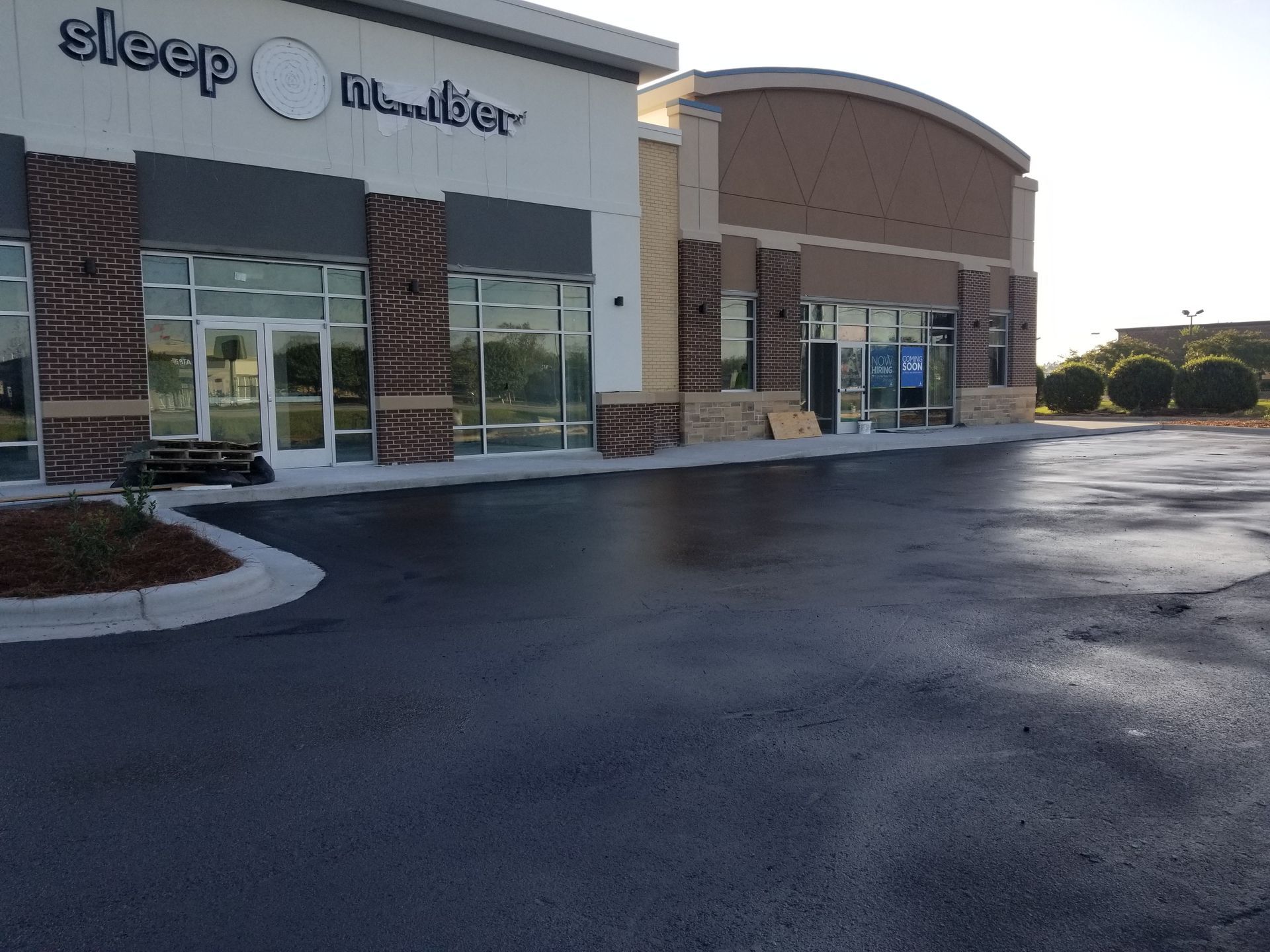 Sleep Number store exterior with wet asphalt.