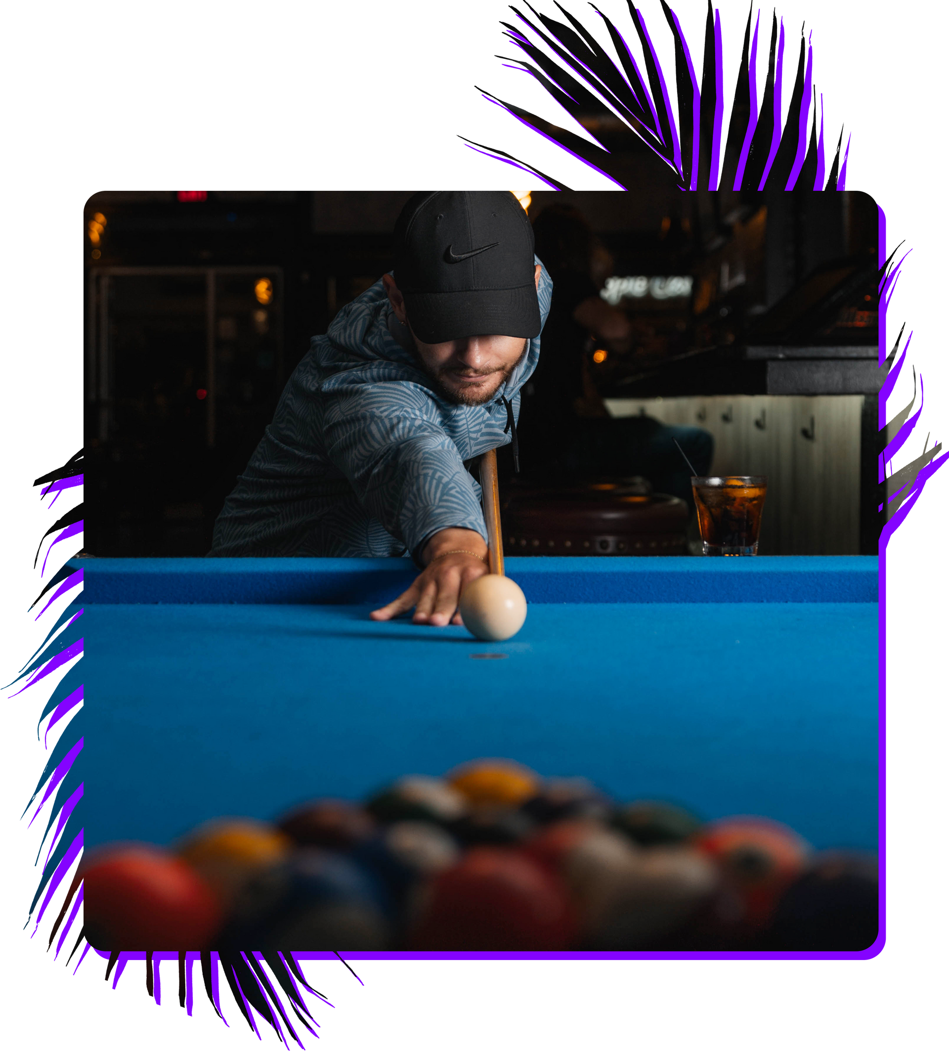 A man is playing pool on a blue pool table.