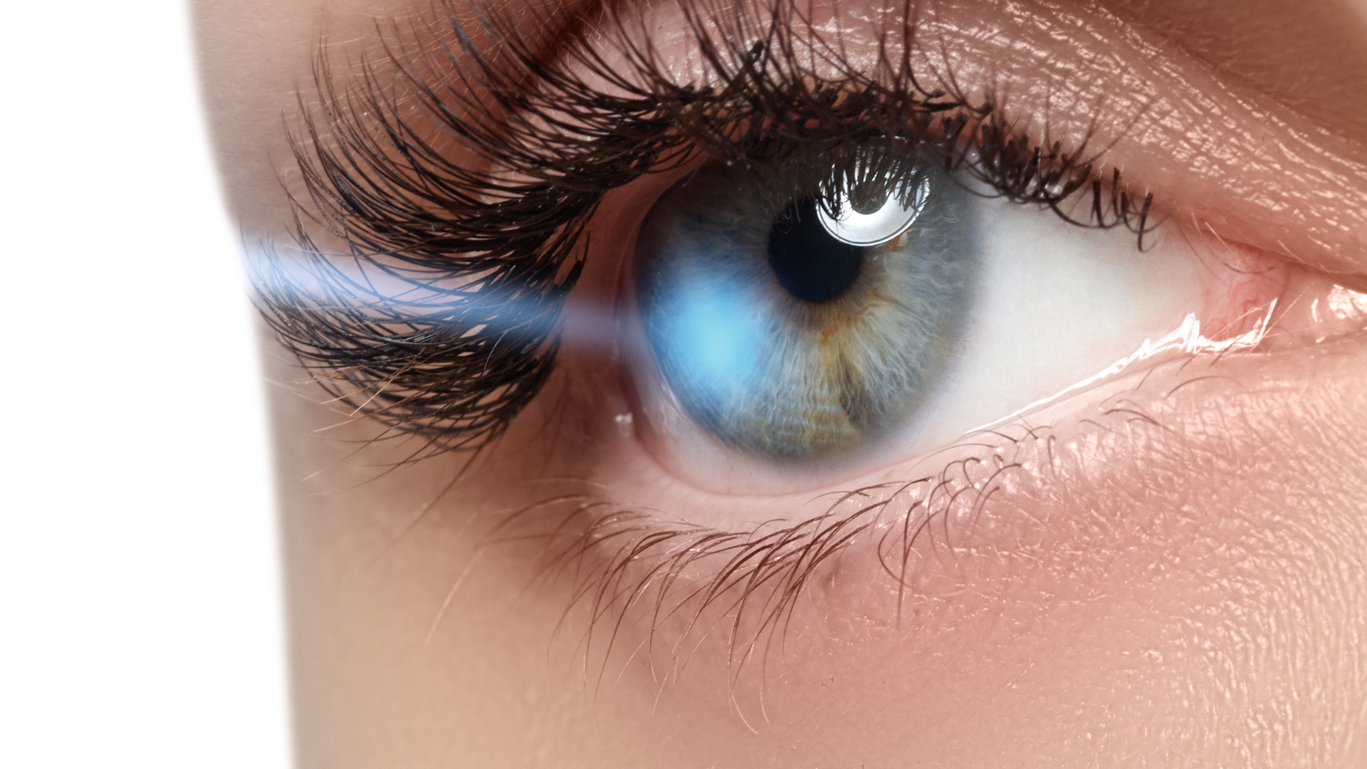 A close up of a woman 's eye with a laser in it.