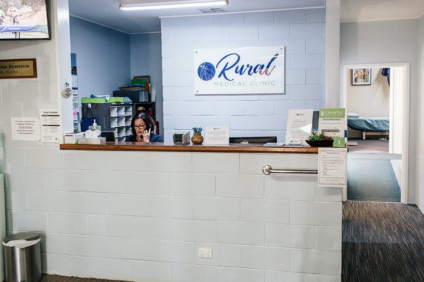 A Woman Is Standing Behind a Reception Desk — Rural Medical Clinic In Manilla, NSW