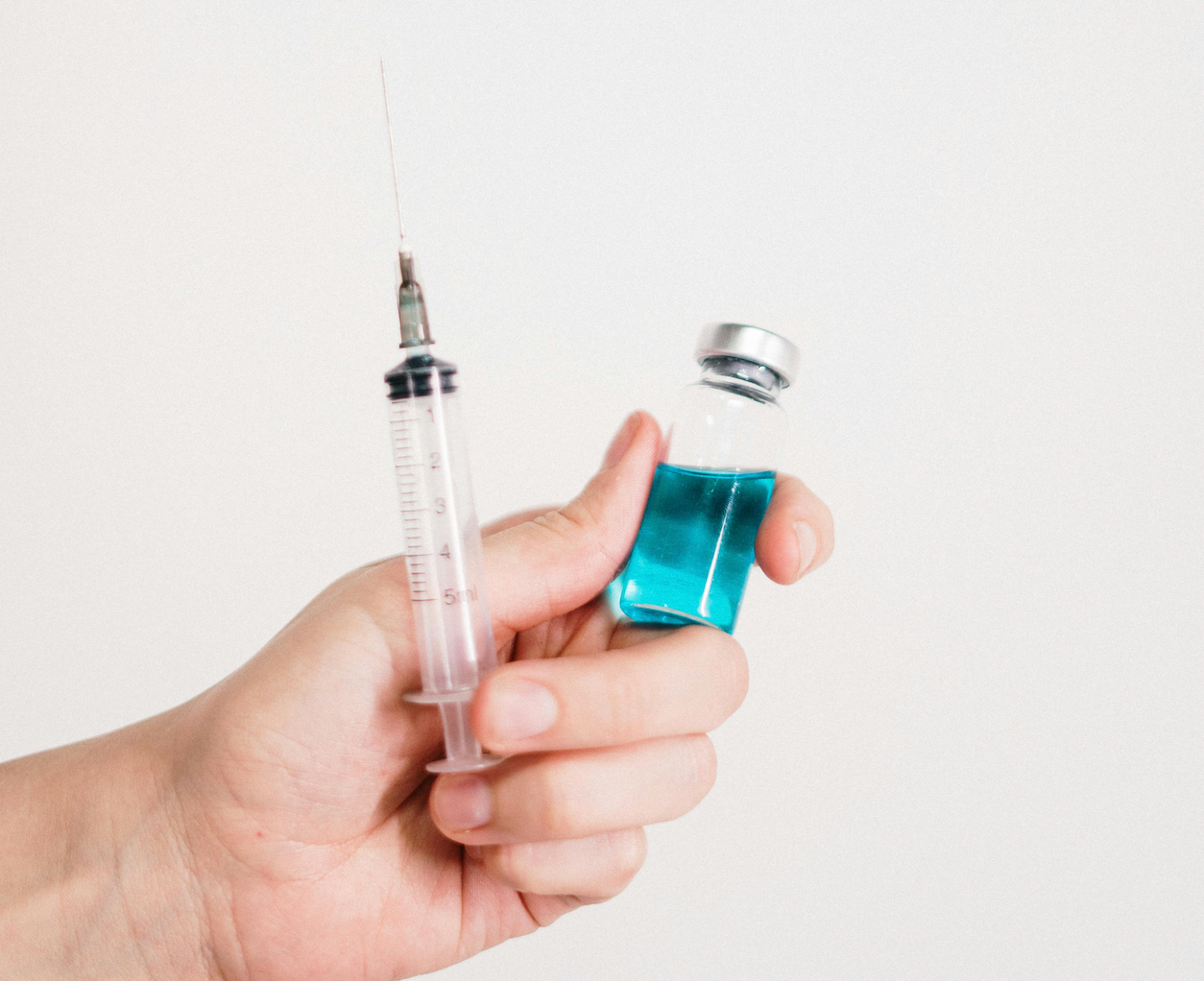 A Syringe Is Being Used To Inject A Vaccine Into A Bottle — Rural Medical Clinic In Manilla, NSW
