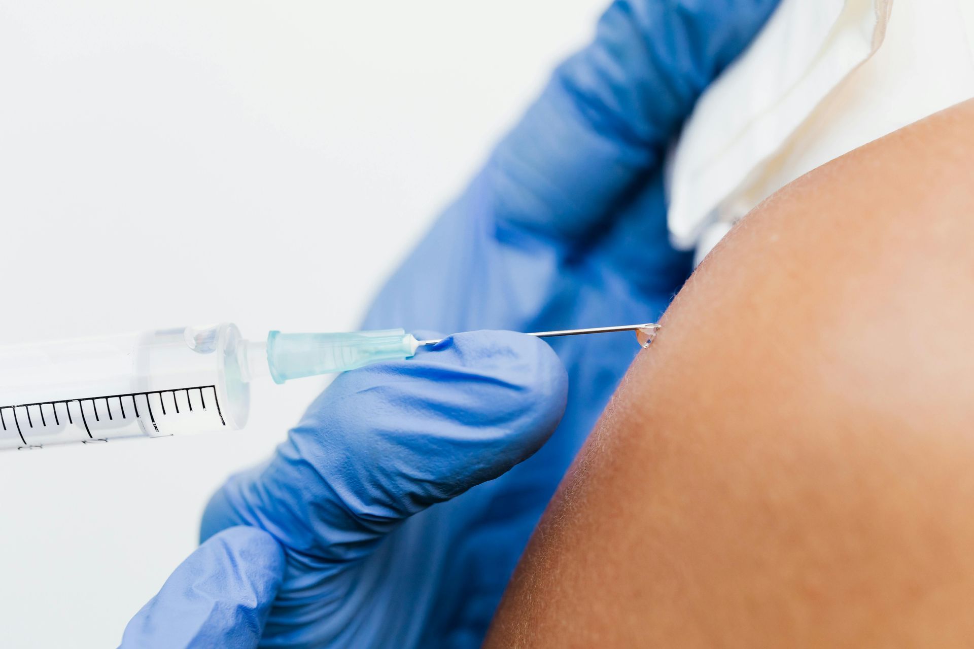 A Woman Is Getting An Injection In Her Arm — Rural Medical Clinic In Manilla, NSW