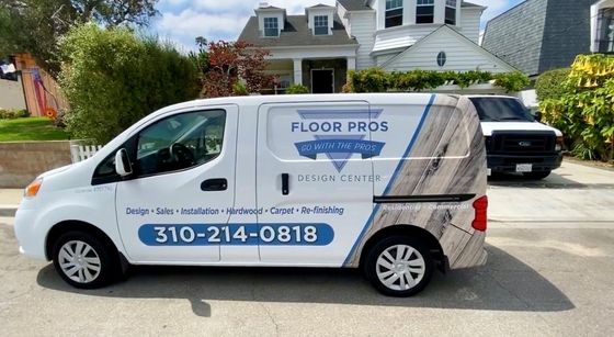 A white van is parked in front of a house.