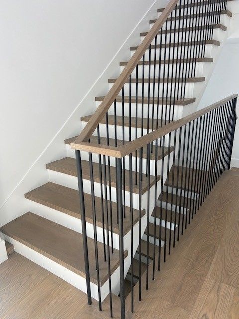 A staircase with wooden steps and a metal railing