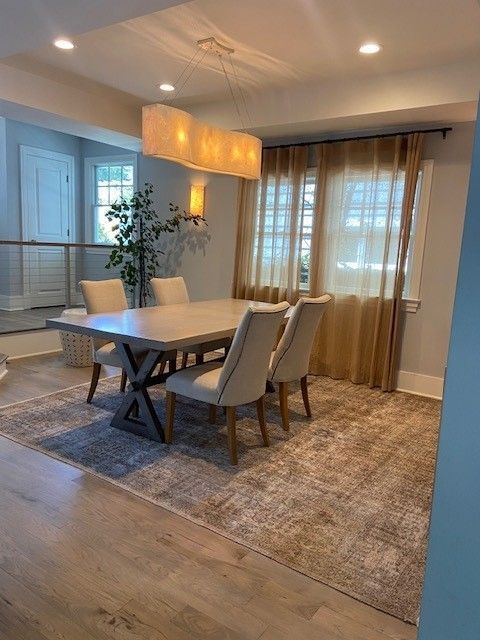 A dining room with a table and chairs and a chandelier.