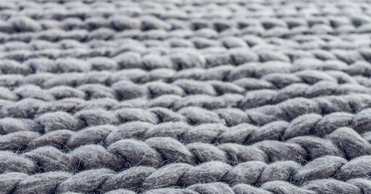 A close up of a gray knitted rug.