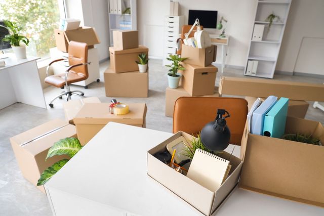 Moving boxes and packed items in a bright room, suggesting a recent office or home move